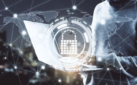 Person using a laptop with a digital lock and calendar icon overlay, symbolizing cybersecurity and data protection by implementing zero trust, with a world map and network connections in the background.