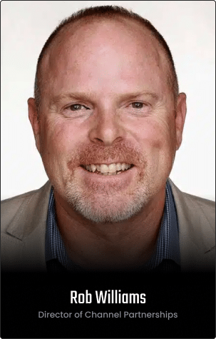 Headshot of a smiling man with light skin and short hair, wearing a beige jacket and blue shirt. Text reads: "Rob Williams, Director of Channel Partnerships." Featured on our Homepage v2.