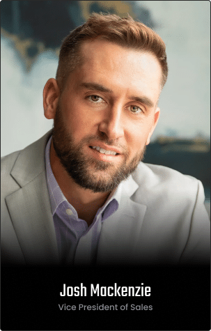 A man with short hair and a beard wearing a light-colored blazer and shirt appears on the Homepage, identified as Josh Mackenzie, Vice President of Sales.