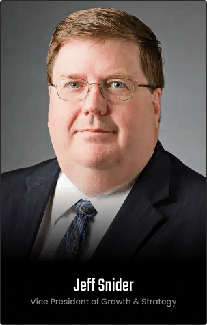 A man in a dark suit, light shirt, and patterned tie poses against a gray background on the v2 Homepage. Text reads: "Jeff Snider, Vice President of Growth & Strategy.