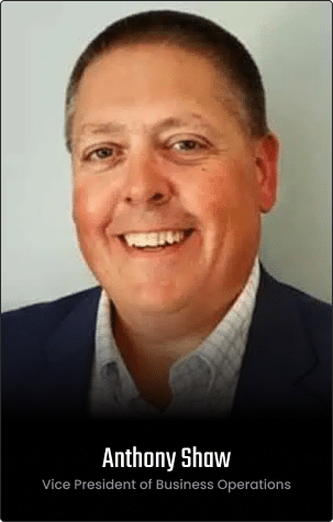 A man in a suit smiles at the camera in a professional headshot featured on the homepage. Text below reads: “Anthony Shaw, Vice President of Business Operations.”.